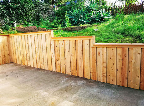 New cedar fence along a driveway